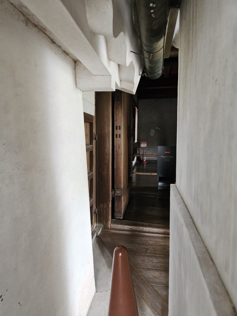 Compressed interior passage focused by wall, floor, and doorway alignment.