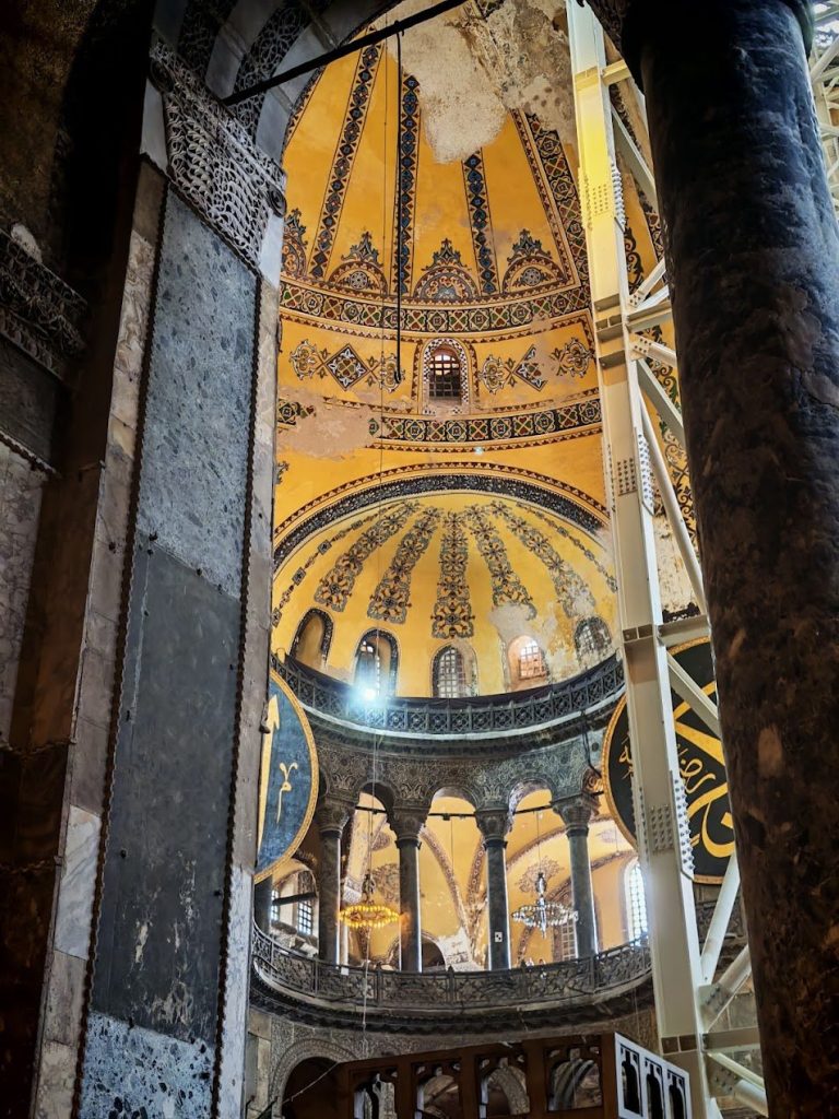 Tall arched interior view layered with structure, surface, and filtered light.
